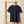 Krabbe unisex bio t-shirt aus Bio-Baumwolle mit eleganter Stickerei, hängend an einem Holzregal.